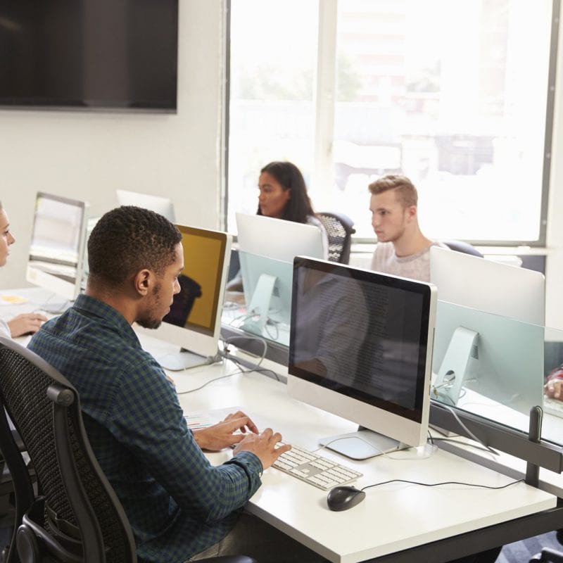 Group Of University Students Using Online Resources