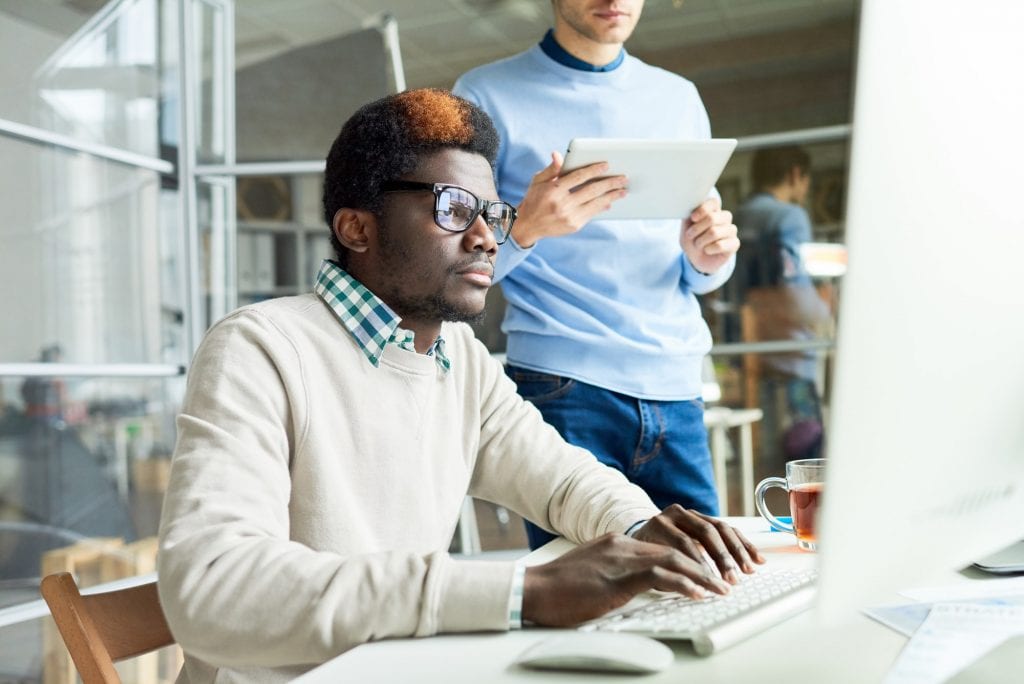 Two Web Developers Working on Code